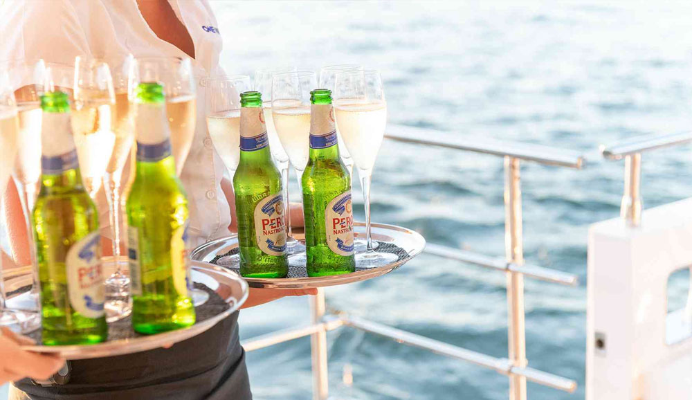 Guests enjoying an event on the One World boat with views of Sydney Harbour